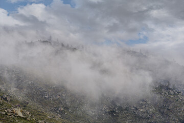 Russia. South of Western Siberia, Mountain Altai. Morning frosty fog on the tops of the rocks along the Biya River.