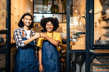 Fototapeta na wymiar Young couple asian man and african woman manager in restaurant with digital tablet or notebookWoman coffee shop owner with face mask hold open sign .Small business concept.