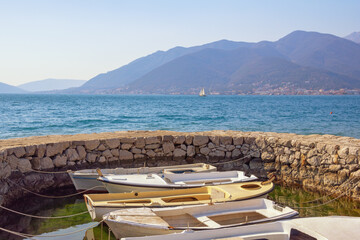 Fototapeta na wymiar Beautiful Mediterranean landscape. Montenegro, Adriatic Sea. View of Bay of Kotor, Tivat. Mandrac (mandrach) - dry stone jetty for fishing boats