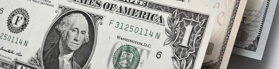 US money banknotes of 1, 10 and 100 dollars. Banner or headline about the American dollar or...