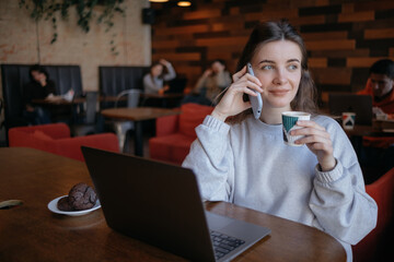 freelance woman happy working in a cafe remotely