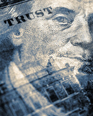 American paper money. 100 dollar bill with portrait of Benjamin Franklin in focus. US banknote closeup. Blue tinted vertical stories about USA dollars. Bonds and treasuries. We trust phrase fragment