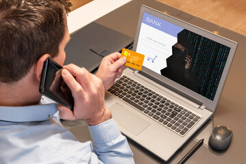 Man making purchases with his credit card over the phone while being scammed by a cyber thief. Vishing scam