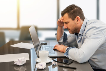 Businessman overwhelmed and distressed by his work in the office. Despair and frustration at work