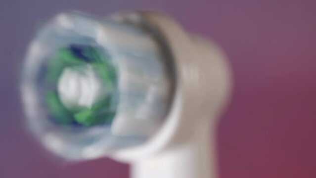 Macro Shot of Electric Toothbrush Head Rotating and Vibrating at High Speed On and Off, Colorful Red and Blue Background 4K Extreme Closeup