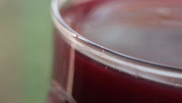 close-up of a glass of turnip juice with drops
