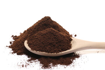 Milled coffee powder pile with wooden spoon isolated on white 