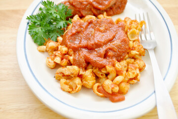 Close Up of a Pasta with Hot Spicy Sausage in the Background