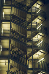 Vertical shot of a staircase in the building at nighttime.