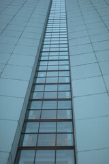 Obraz premium High-rise building on gray day. Architecture details. Surface of wall.