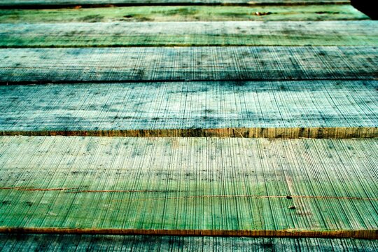 Los tablones de madera de pino verde para la construcción de casas, para secado y apilados al aire libre, forman un hermoso diseño abstracto y rústico para los fondos