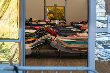 Temporary beds in a camp for refugees from Ukraine in Krakow, Poland. Temporary shelter for...