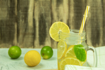 Fresh citrus lemonade with mint on a rustic background