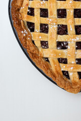 piece of homemade cherry wicker pie on a white table