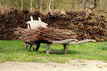 vintage wooden cart filled with twigs 