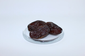 Fresh dried dates Medjool, close-up isolated on white background.