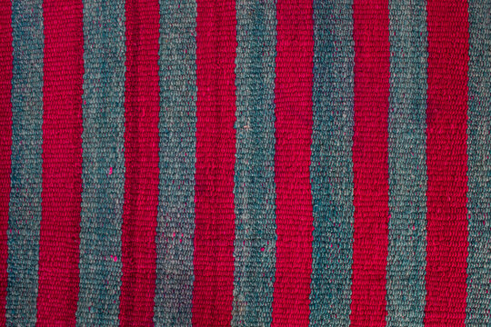 old handmade wool bed andean culture of bolivia texture red and green background