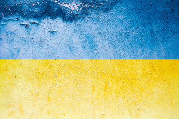 Flag of Ukraine on old grunge wall blue yellow color. Peeled paint on a concrete wall.