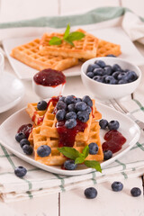 Waffles with blueberries and jam. 