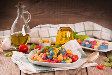 Colored gnocchi with vegetables and sweet corn.