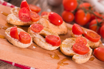 Friselle with cherry tomatoes and olive oil.