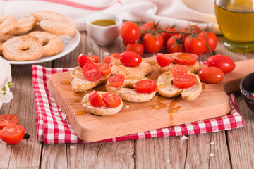 Friselle with cherry tomatoes and olive oil.