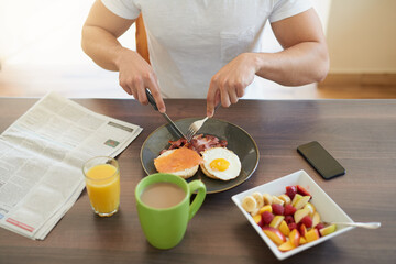 Start your morning off right. Cropped shot of a bachelor enjoying breakfast at home.