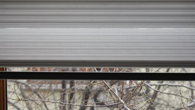 the roller blind of a window opens
