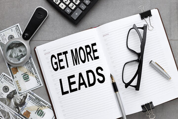 Get More Leads. test on an open notepad near a magnifying glass and money on a gray background