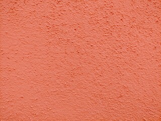 Fototapeta premium Stucco texture in salmon-colored cement.