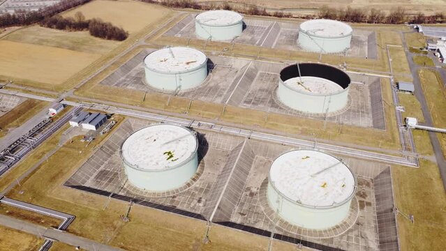 Aerial moving 4K view of an industrial area with a fossil oil storage facility
