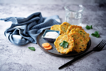 Corn fritters with carrots and parsley