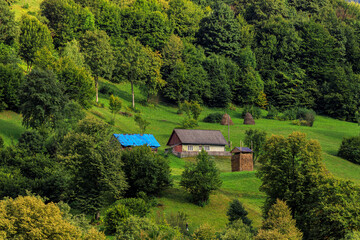 Fototapeta na wymiar Mountains in the summer in sunny weather and houses