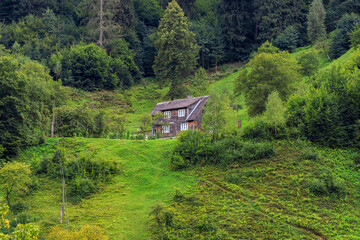 Mountains in the summer in sunny weather and houses