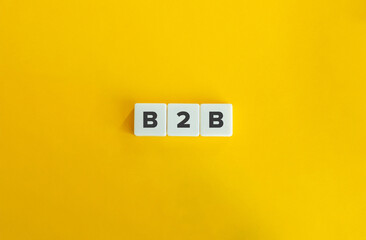 Business to business (B2B) Banner. Letter Tiles on Yellow Background. Minimal Aesthetics.