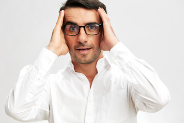 man with glasses in white shirts holding his head copy-space isolated background