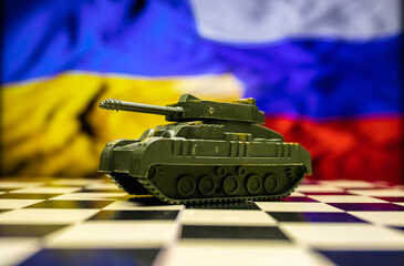 War between Russia and Ukraine, conceptual image of war using chess board, tank, national flags on the background. Ukrainian & Russian crisis, political conflict. Stop the war 2022