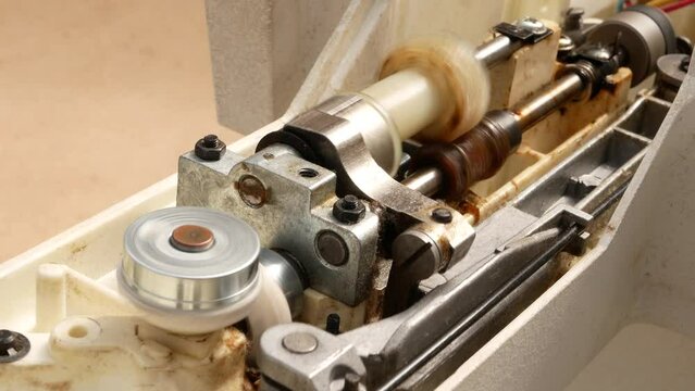 The rotating shaft transmits the force through bevel gears and an eccentric mechanism with cam gear