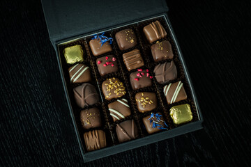 Box of delicious handmade chocolates. Fancy gift box of assorted candies or truffles. 
