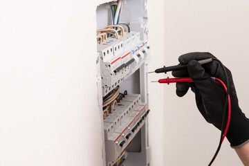 Electrician works with electrical automated. Electrical switchboard with automatic and wires