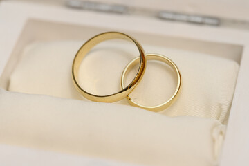Two golden wedding rings. Close-up view of white golden wedding rings in a box