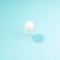 Egg in a glass of champaigne.Simple and nice design.Pale blue layout