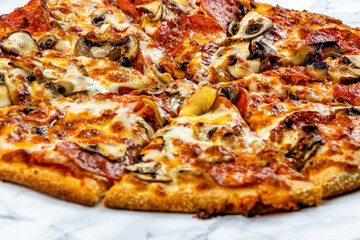 Pepperoni and mushroom pizza on a marble surface. Calgary, Alberta, Canada