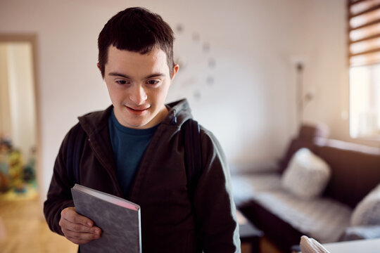 Young Student With Down Syndrome Ready For First Day Of School At Home.