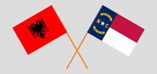 Crossed flags of Albania and The State of North Carolina. Official colors. Correct proportion