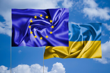 EU flag and Ukrainian flag against the sky