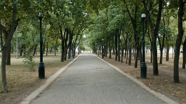Path in the park in tiraspol, transistria, part of former russian enclave. Drone walk through the park.