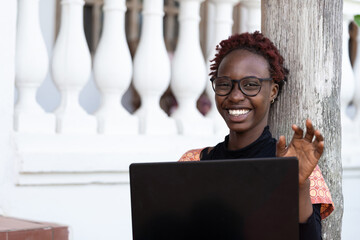 Portrait of creative young African businesswoman working on a laptop. African female...