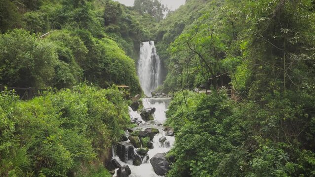 Timlapse of Cascadas de Peguche, a small waterfall in a lush green environmnent in Ecuador, close to Otavalo.