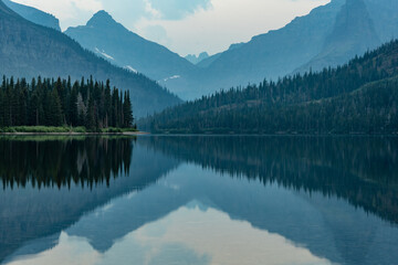 Layers of Two Medicine Reflects In The Still Lake Below